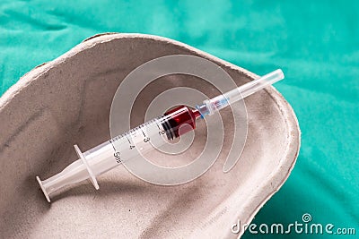 Medical syringe, bloodsample lying in a one use capsule Stock Photo