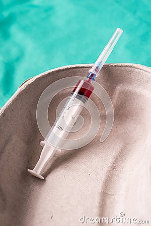 Medical syringe, bloodsample lying in a one use capsule Stock Photo