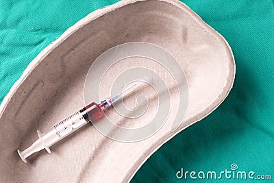 Medical syringe, bloodsample lying in a one use capsule Stock Photo