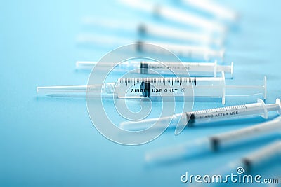 Medical syringes on a blue background Stock Photo