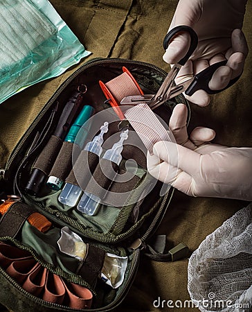 Medical tape cutting during first aid in an emergency Stock Photo