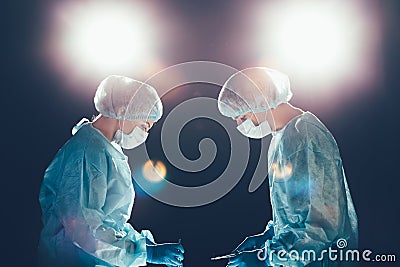 Medical team hospital performing operation. Group of surgeon at work in operating theatre room. healthcare . Stock Photo