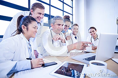 Medical team looking into laptop and having a discussion Stock Photo