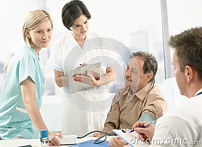 Medical team measuring blood pressure Stock Photo