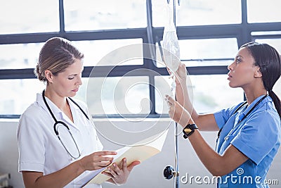 Medical team preparing an IV drip Stock Photo