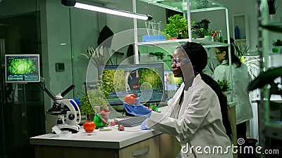 Medical team researcher working in pharmacology laboratory examining organic food Stock Photo