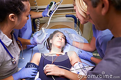 Medical Team Working On Patient In Emergency Room Stock Photo