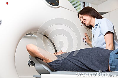 Medical technical assistant preparing scan of the spine with CT Stock Photo