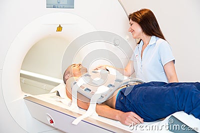 Medical technical assistant preparing scan of torso with MRI Stock Photo