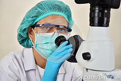 Medical technologist working with microscope Stock Photo