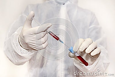 Medical technologists inject blood into a test tube in a science laboratory by analyzing blood results for antiretroviral drugs. Stock Photo