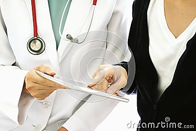 Medical technology concept, Patient asking doctor about her sickness conditions by using tablet computer. Stock Photo