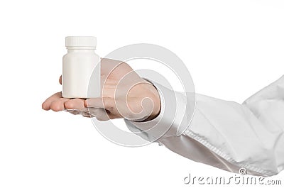 Medical theme: doctor's hand holding a white empty jar of pills on a white background Stock Photo