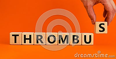 Medical and and thrombus symbol. Wooden cubes with the word `thrombus`. Beautiful orange background. Doctor hand. Medical and Stock Photo