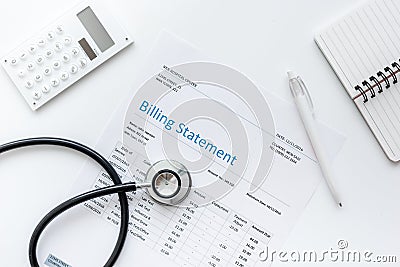 Medical treatmant billing statement with stethoscope and calculator on white background top view mock up Stock Photo