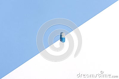 Medical white-blue capsule pill on abstract background Stock Photo