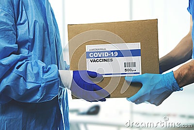 medical worker accepting delivery of covid-19 vaccines from deliveryman Stock Photo