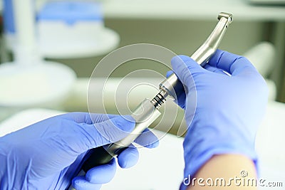 A medical worker connects a disassembled boron machine for dental treatment, preparation for treatment, repair of a medical Stock Photo