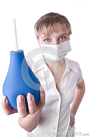 Medical worker holding a blue enema in her hands Stock Photo