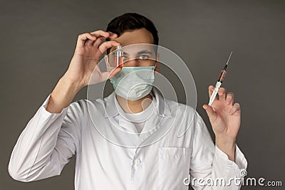 A medical worker holds a vaccine against a deadly virus Stock Photo