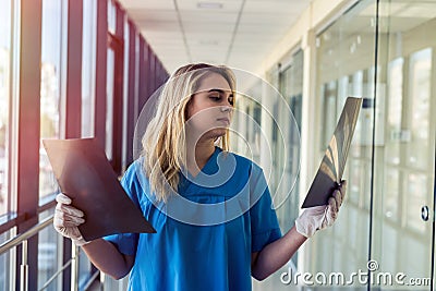 Medical worker looks at xray film of the skull to detect signs of the disease Stock Photo