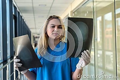 Medical worker looks at xray film of the skull to detect signs of the disease Stock Photo