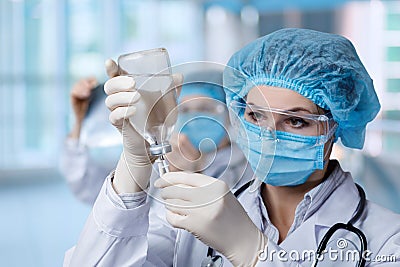 Medical worker prepares a drip of medicen into for installation Stock Photo