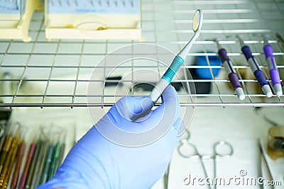 A medical worker puts a medical instrument in a device for disinfection and cleaning of germs. Stylishness and cleanliness in Stock Photo