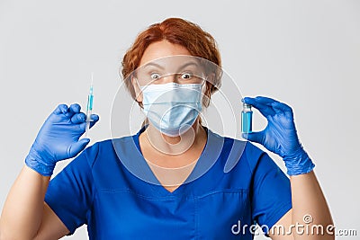 Medical workers, covid-19 pandemic, coronavirus concept. Amazed and excited female doctor in face mask and gloves Stock Photo