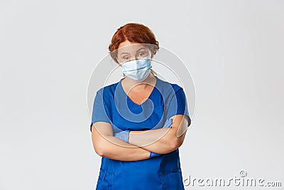 Medical workers, covid-19 pandemic, coronavirus concept. Skeptical and judgemental, serious-looking female doctor Stock Photo