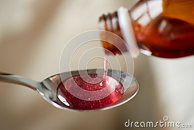 Medication or antipyretic syrup and spoon Stock Photo