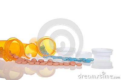 Medication bottles spilled on reflective surface Stock Photo