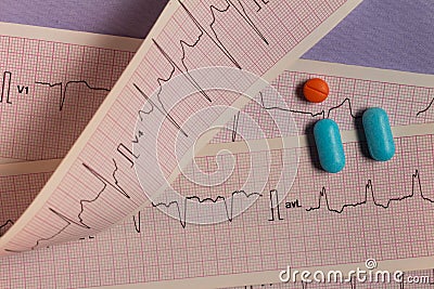 Medications in the form of tablets for oral use on an electrocardiogram background. Stock Photo