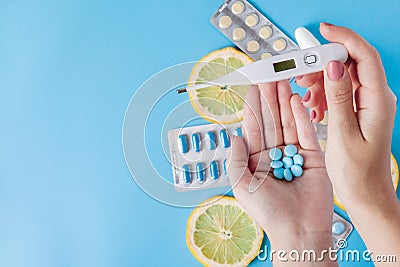 Medications, pills, thermometer, traditional medicine for treating colds, flu, heat on a blue background. Maintenance of immunity Stock Photo