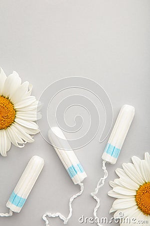 Medicinal chamomile flower and menstrual sanitary tampon. Woman critical days, gynecological menstruation cycle Stock Photo