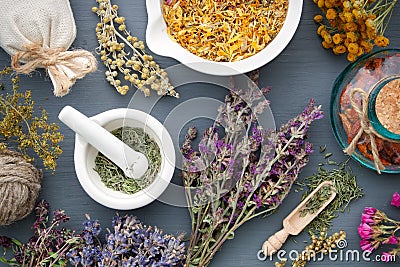 Medicinal herbs, mortar of herbs, sachet and bottle of drug. Stock Photo