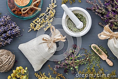 Medicinal herbs, mortar, sachet and bottle of drugs. Stock Photo
