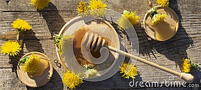 Medicinal honey dandelion with spoon on wooden table Stock Photo