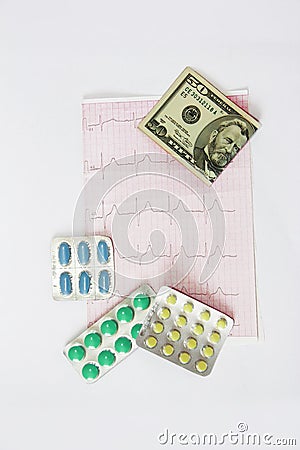 Medicinal pills, dollars on the background of the cardiogram Stock Photo