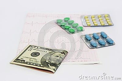 Medicinal pills, dollars on the background of the cardiogram Stock Photo