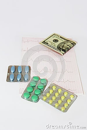 Medicinal pills, dollars on the background of the cardiogram Stock Photo