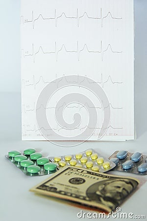 Medicinal pills, dollars on the background of the cardiogram Stock Photo