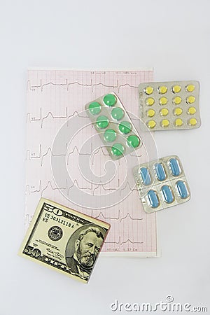 Medicinal pills, dollars on the background of the cardiogram Stock Photo