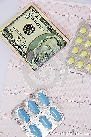 Medicinal pills, dollars on the background of the cardiogram Stock Photo