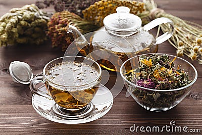 Medicinal tea in glass cup with dried herb in bowl Stock Photo