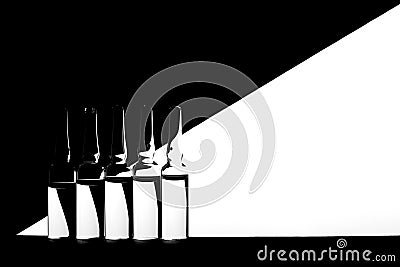 Medicine ampoules on black and white geometric background. Stock Photo