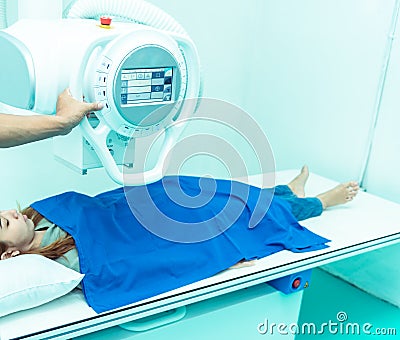 Medicine concept ,Technician Doctor male radiologist with colleague setting up machine to take female patient in x-ray room Stock Photo