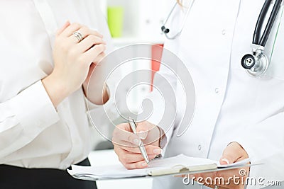 Medicine doctor explains the results of medical research to female pacient. Partnership, trust and medical ethics Stock Photo