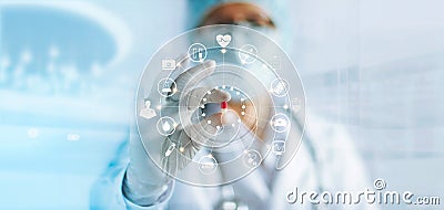 Medicine doctor holding a color capsule pill in hand with icon medical network connection on modern virtual screen interface in la Stock Photo