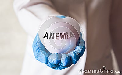 Medicine, a doctor in a white coat holds in his hands a toy heart with the inscription. The young doctor in health care concept Stock Photo